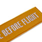 Schluesselanhaenger REMOVE BEFORE FLIGHT Sunshine detail
