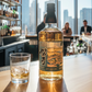 The Matsui Mizunara Cask Japanese Single Malt Whisky mit Glas auf Bartresen, im Hintergrund moderne Bar mit Stadtblick und Gästen